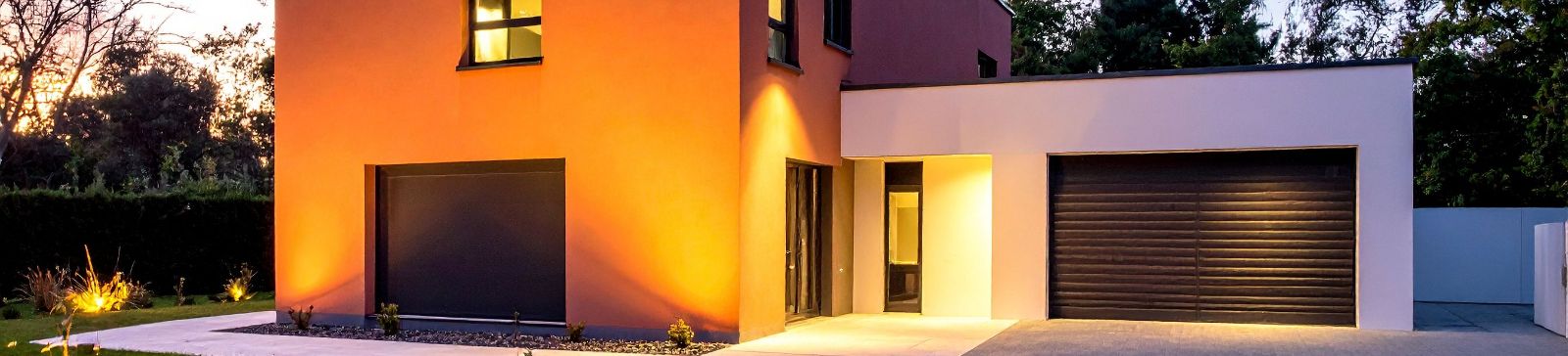 Contemporary home at sunset with sleek, horizontal paneled garage door installed by Garage Door Repair Antelope