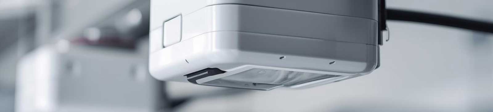 Close-up of modern garage door opener sensor installed in an Antelope CA home.