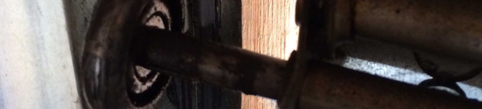 Damaged, rusted garage door roller before replacement in Antelope CA