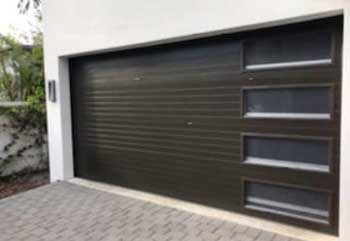 Modern horizontal steel garage door with four tall windows for stylish curb appeal in Orangevale CA